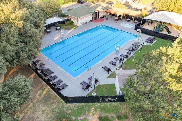 aerial view of property and surrounding area featuring a pool area