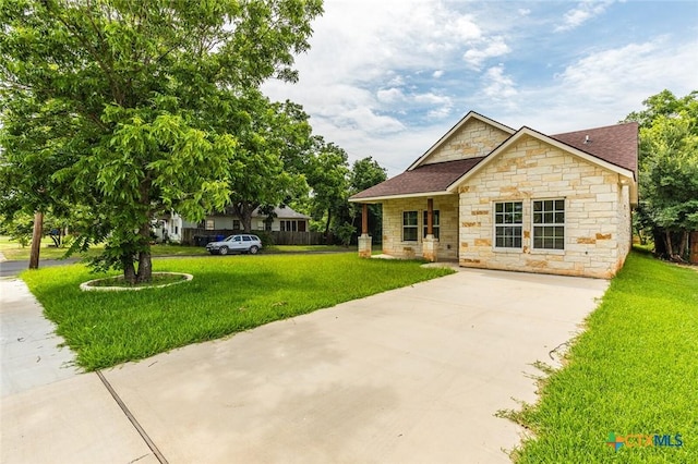 1700 Proctor Ave, Waco, TX 76708 - view of front facade featuring stone siding, concrete driveway, a front yard, and a shingled roof