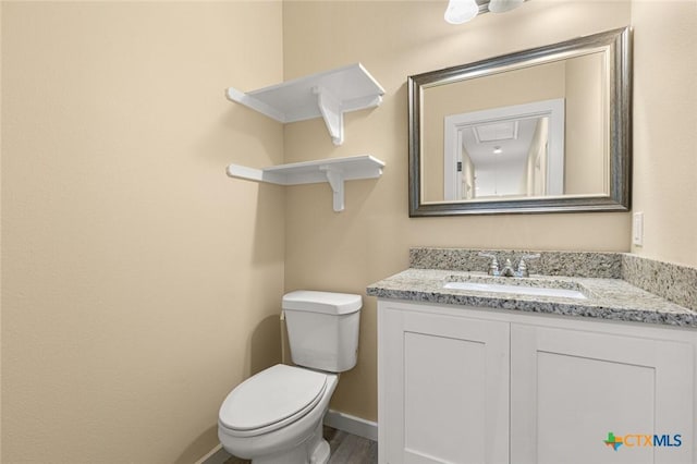 1700 Proctor Ave, Waco, TX 76708 - bathroom with vanity, toilet, baseboards, and wood finished floors