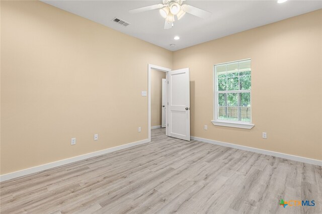 spare room featuring light hardwood / wood-style floors and ceiling fan