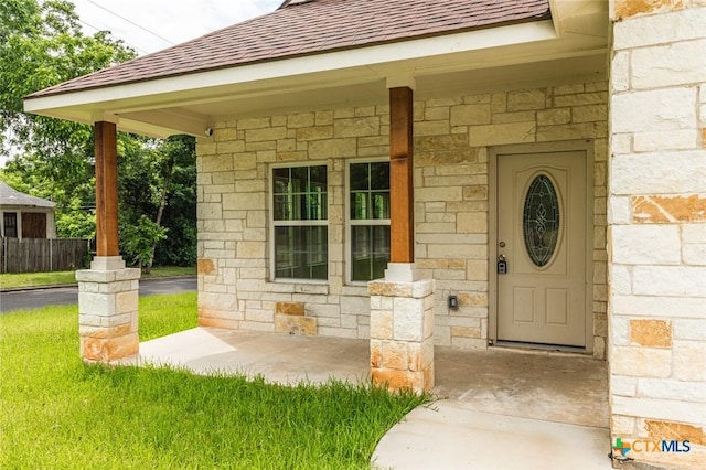 1700 Proctor Ave, Waco, TX 76708 - doorway to property featuring stone siding and roof with shingles