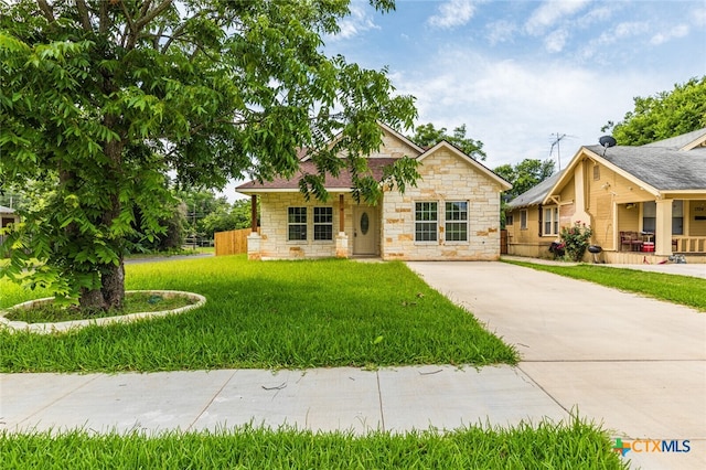 1700 Proctor Ave, Waco, TX 76708 - view of front facade featuring stone siding, driveway, and covered porch