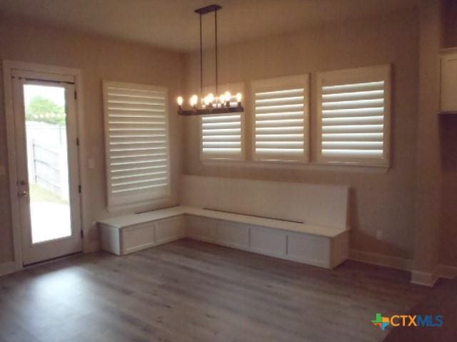 791 Hazy Hills Loop, Dripping Springs, TX 78620 - unfurnished dining area with wood finished floors and a chandelier