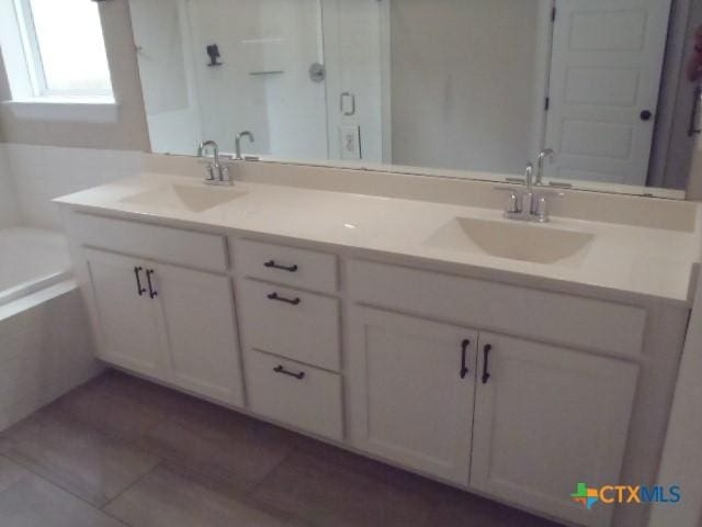 791 Hazy Hills Loop, Dripping Springs, TX 78620 - bathroom featuring double vanity, a bath, and tile patterned floors