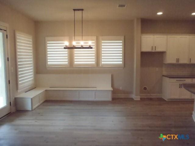 791 Hazy Hills Loop, Dripping Springs, TX 78620 - unfurnished dining area featuring light wood-style flooring and recessed lighting