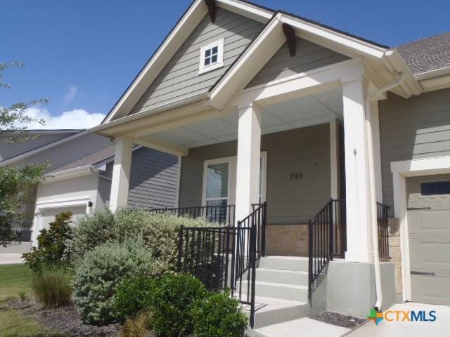 791 Hazy Hills Loop, Dripping Springs, TX 78620 - view of front of property featuring a porch and a garage