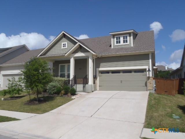 791 Hazy Hills Loop, Dripping Springs, TX 78620 - craftsman inspired home with concrete driveway, an attached garage, a front yard, and a porch