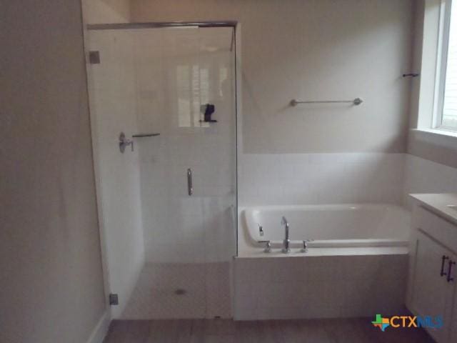 791 Hazy Hills Loop, Dripping Springs, TX 78620 - full bath featuring a stall shower, a garden tub, and vanity