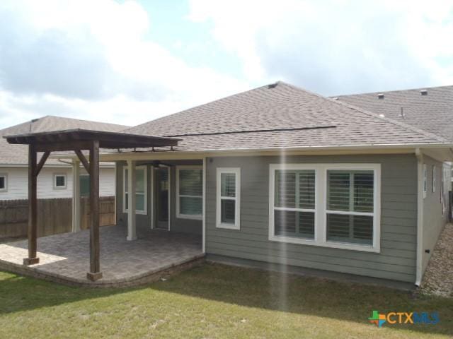 791 Hazy Hills Loop, Dripping Springs, TX 78620 - rear view of house featuring a shingled roof and a patio