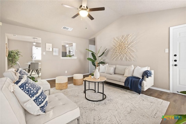 living room with lofted ceiling, wood-type flooring, and ceiling fan