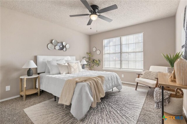 bedroom with ceiling fan, carpet floors, a closet, and a textured ceiling