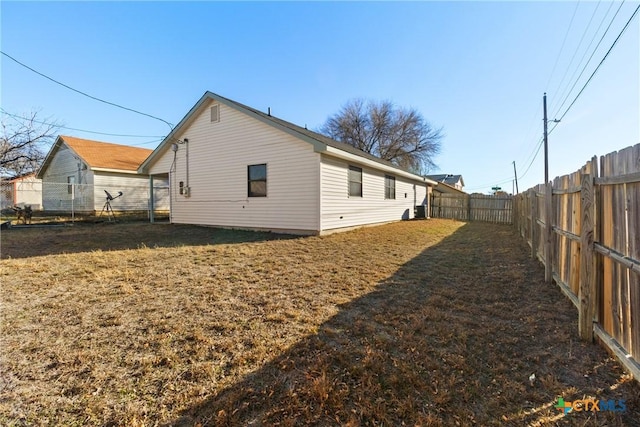 view of side of home with a lawn