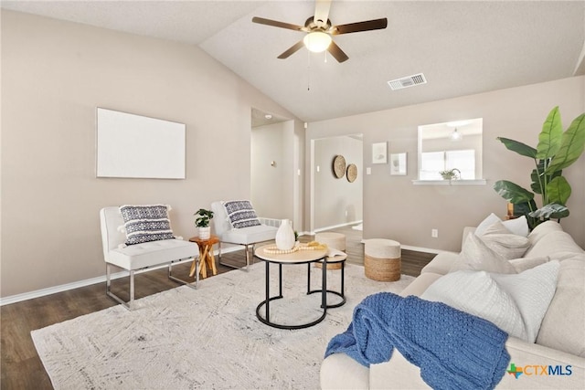 living room with ceiling fan, lofted ceiling, and dark hardwood / wood-style flooring