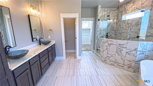 bathroom featuring vanity, tile patterned flooring, and a shower with shower door