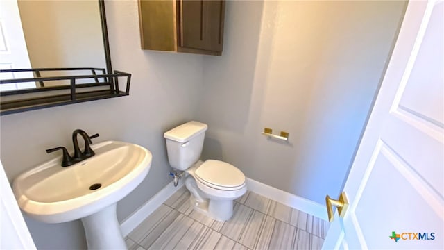 bathroom with tile patterned flooring and toilet