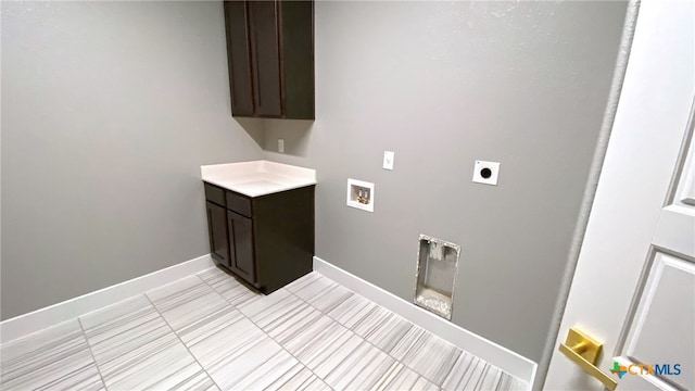 laundry room featuring cabinets, hookup for a washing machine, and hookup for an electric dryer