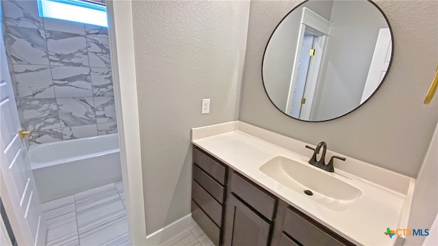 bathroom with vanity, tile patterned floors, and tiled shower / bath