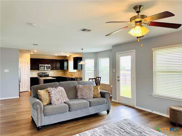 3413 Malmaison Rd, Killeen, TX 76542 - living area with wood finished floors, baseboards, and a ceiling fan
