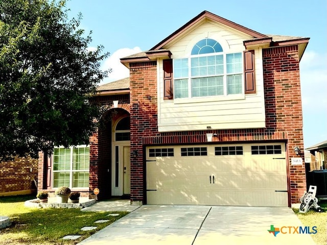 view of front of house with a garage and cooling unit