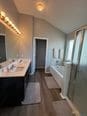 bathroom featuring vaulted ceiling and hardwood / wood-style flooring