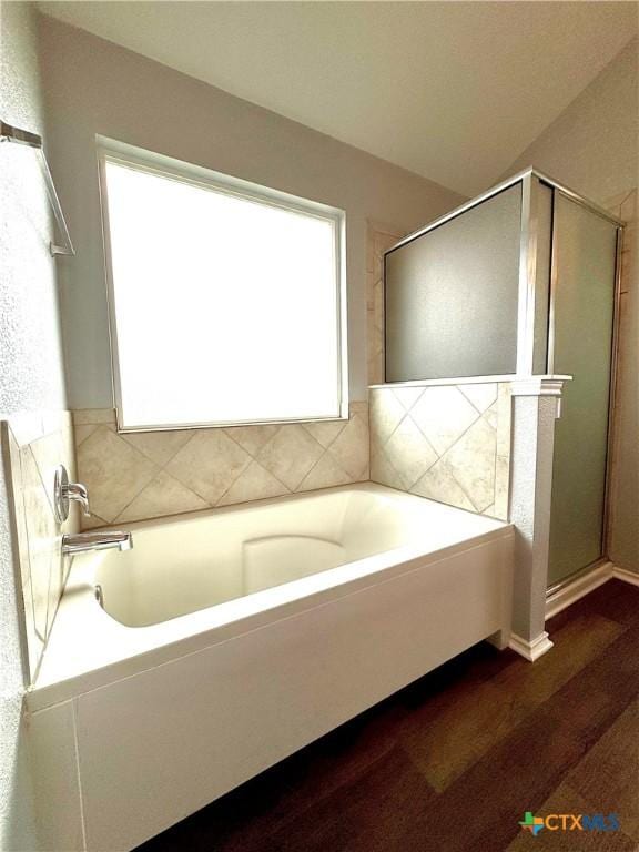 3413 Malmaison Rd, Killeen, TX 76542 - bathroom with wood finished floors, a bath, and a stall shower