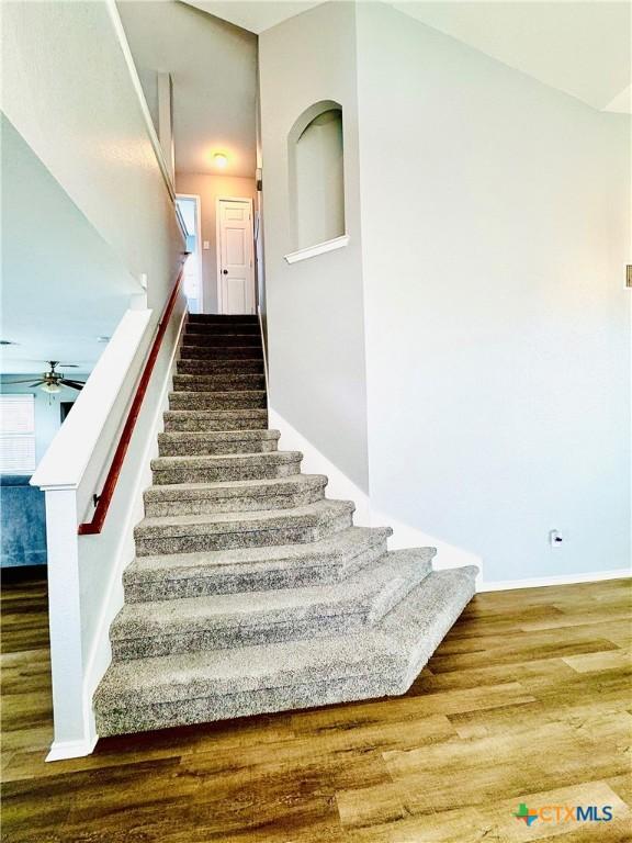 3413 Malmaison Rd, Killeen, TX 76542 - staircase featuring wood finished floors, a ceiling fan, and baseboards