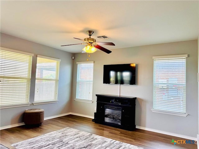 3413 Malmaison Rd, Killeen, TX 76542 - unfurnished living room with wood finished floors, ceiling fan, and baseboards