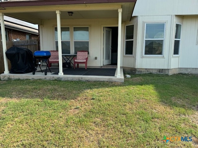 rear view of property with a lawn and a patio area