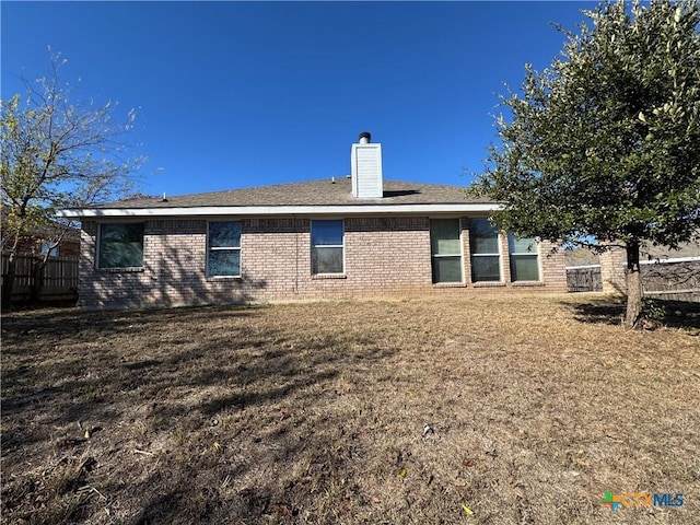 back of house featuring a yard