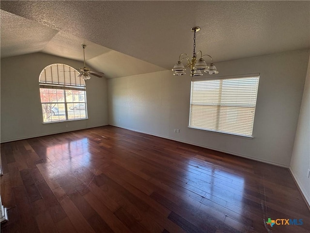 unfurnished dining area with a textured ceiling, dark hardwood / wood-style flooring, and vaulted ceiling