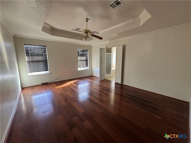 spare room with dark hardwood / wood-style floors, a raised ceiling, ceiling fan, and crown molding