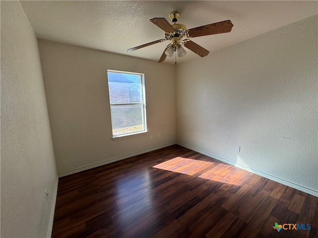 spare room with a textured ceiling, dark hardwood / wood-style flooring, and ceiling fan