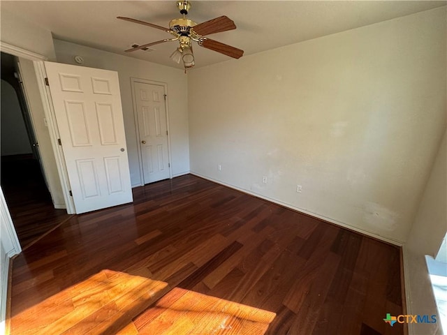 unfurnished bedroom with ceiling fan and dark hardwood / wood-style flooring