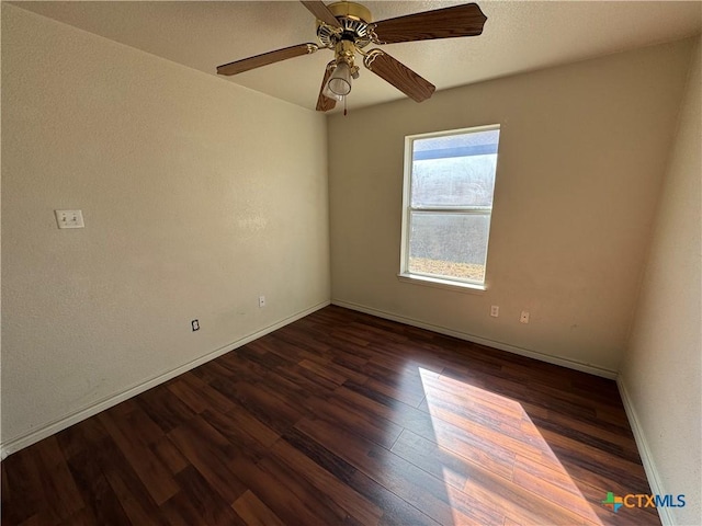 unfurnished room featuring dark hardwood / wood-style floors and ceiling fan