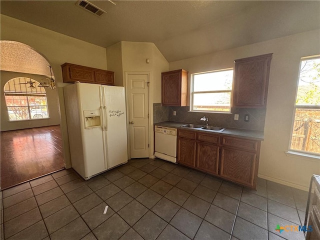 kitchen with plenty of natural light, hardwood / wood-style floors, white appliances, and sink