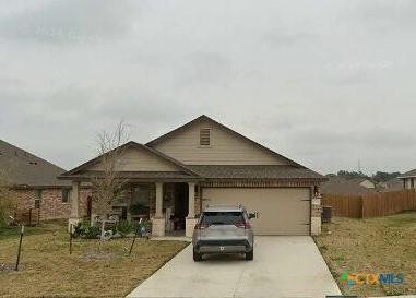 view of front facade featuring a garage and a front lawn