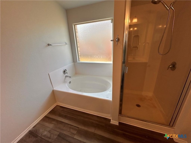 bathroom with hardwood / wood-style flooring and plus walk in shower