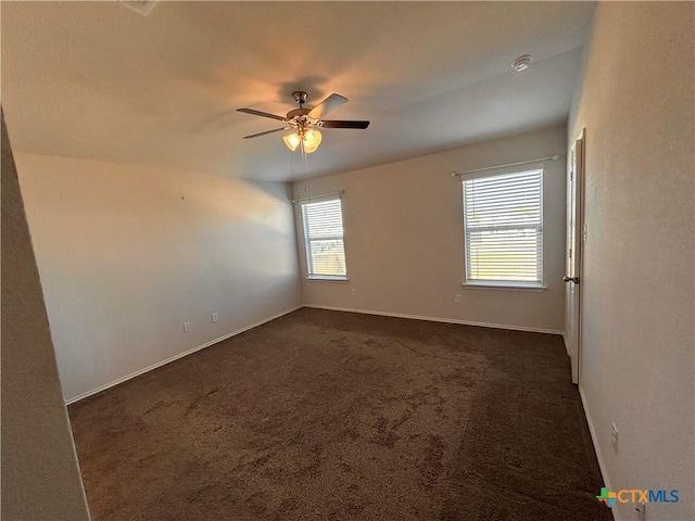 carpeted empty room featuring ceiling fan