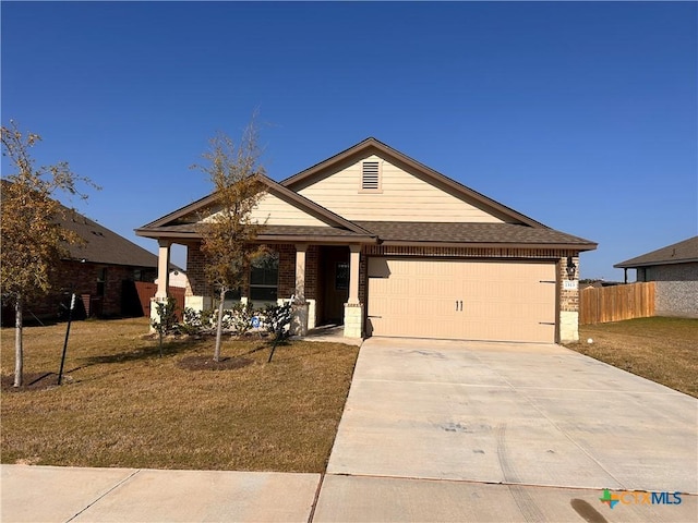 view of front of property featuring a front yard and a garage