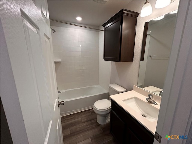 full bathroom with wood-type flooring, vanity, toilet, and tiled shower / bath