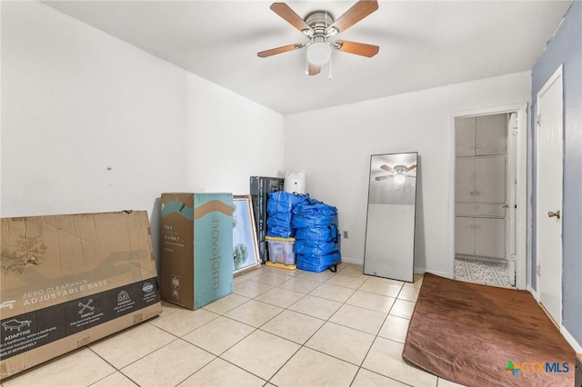 interior space featuring light tile patterned floors and ceiling fan