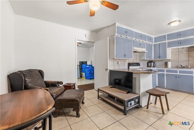 kitchen featuring sink, blue cabinetry, electric range, tasteful backsplash, and light tile patterned flooring