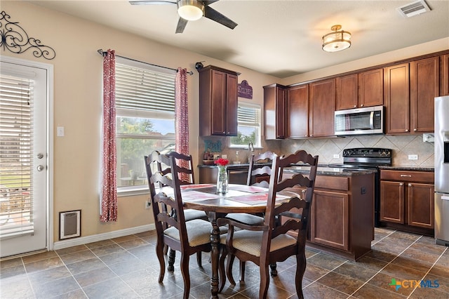 326 Comal Run, Hutto, TX 78634 - dining space with a ceiling fan and dark stone finish floors