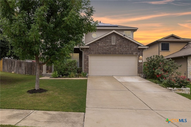 326 Comal Run, Hutto, TX 78634 - view of front of property with brick siding, roof mounted solar panels, concrete driveway, and an attached garage