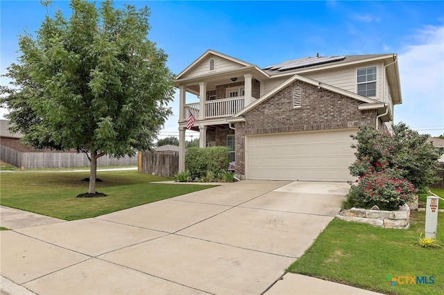 326 Comal Run, Hutto, TX 78634 - view of front of home with solar panels, a balcony, brick siding, driveway, and an attached garage