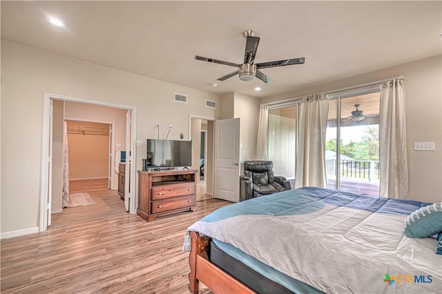 bedroom with ceiling fan, light hardwood / wood-style floors, access to outside, a spacious closet, and a closet