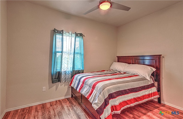 bedroom featuring ceiling fan and hardwood / wood-style flooring