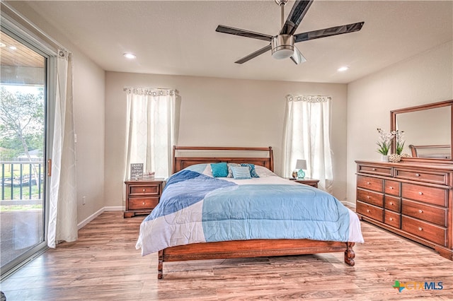 bedroom with ceiling fan, access to exterior, multiple windows, and light wood-type flooring