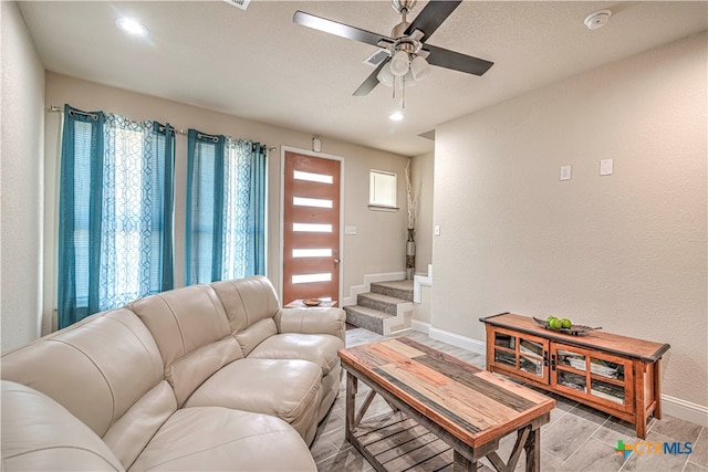 living room featuring ceiling fan and plenty of natural light