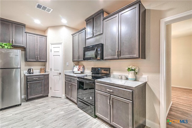 kitchen with light hardwood / wood-style flooring, dark brown cabinetry, and black appliances